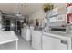 Functional laundry room featuring multiple washers and dryers and ample storage space at 8405 112Th St # 103, Seminole, FL 33772