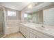 Bathroom with double sinks, large mirror, combination tub and shower and neutral color scheme at 8526 Hawbuck St, Trinity, FL 34655