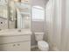 Bathroom featuring a single sink, toilet, and shower/tub combination with neutral color scheme at 8526 Hawbuck St, Trinity, FL 34655