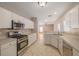 Kitchen with white cabinets, stainless steel appliances, and a view of the living room at 8526 Hawbuck St, Trinity, FL 34655