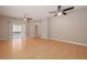 Spacious living room with neutral paint, laminate flooring, ceiling fans, and sliding glass doors at 8526 Hawbuck St, Trinity, FL 34655