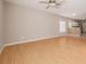 Open living area with laminate flooring, neutral paint, and a view of the kitchen at 8526 Hawbuck St, Trinity, FL 34655