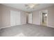 Spacious main bedroom featuring neutral color scheme, carpet flooring, ceiling fan and ensuite bathroom at 8526 Hawbuck St, Trinity, FL 34655
