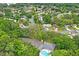 Aerial view of neighborhood amenities featuring a community pool and nearby parking area at 8700 Wind Mill Dr, New Port Richey, FL 34655