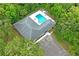 Overhead view showcasing community pool area with an L-shaped pool, restrooms, and parking at 8700 Wind Mill Dr, New Port Richey, FL 34655