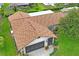 Aerial shot displaying the home's updated roof and lush surroundings at 8700 Wind Mill Dr, New Port Richey, FL 34655