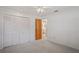 Bedroom featuring carpet floors, a ceiling fan, and a closet with large doors at 8700 Wind Mill Dr, New Port Richey, FL 34655