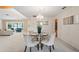 Elegant dining room with a chandelier and views into the living room, featuring neutral tones and natural light at 8700 Wind Mill Dr, New Port Richey, FL 34655
