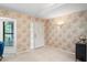 Inviting foyer with tiled flooring, decorative wallpaper, and natural light from a window at 8700 Wind Mill Dr, New Port Richey, FL 34655