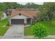 Charming single-story home with brick accents, mature landscaping, and a two-car garage at 8700 Wind Mill Dr, New Port Richey, FL 34655
