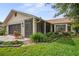 Charming single-story home with brick accents, mature landscaping, and a two-car garage at 8700 Wind Mill Dr, New Port Richey, FL 34655