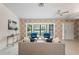 Cozy living room with a bay window, neutral carpet, and comfortable seating arrangement at 8700 Wind Mill Dr, New Port Richey, FL 34655