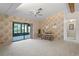 Spacious living room with a ceiling fan and sliding glass doors to an outdoor space at 8700 Wind Mill Dr, New Port Richey, FL 34655
