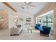 Bright living room featuring neutral carpeting, vaulted ceilings, and large windows for natural light at 8700 Wind Mill Dr, New Port Richey, FL 34655