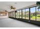 Spacious sunroom enclosed with windows offers peaceful views of the lush outdoor surroundings at 8700 Wind Mill Dr, New Port Richey, FL 34655