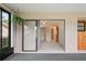 Open sunroom featuring neutral walls and flooring with seamless access to the outdoors and interior spaces at 8700 Wind Mill Dr, New Port Richey, FL 34655