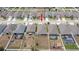 An aerial view of a home, showcasing its position within a neighborhood with well-maintained yards at 905 Old Windsor Way, Spring Hill, FL 34609