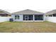 A partially screened backyard featuring white vinyl privacy fencing and lush green grass at 905 Old Windsor Way, Spring Hill, FL 34609