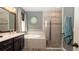 Bright bathroom featuring a tiled soaking tub, shower and dual vanity sink at 905 Old Windsor Way, Spring Hill, FL 34609