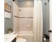 Clean bathroom with a tiled shower and tub combination, neutral colors and modern fixtures at 905 Old Windsor Way, Spring Hill, FL 34609