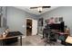 Gray bedroom featuring two desks, fan, window, carpet and view to dining room at 905 Old Windsor Way, Spring Hill, FL 34609