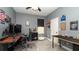 Cozy gray bedroom featuring two desks, window, fan, decor, and gaming setup at 905 Old Windsor Way, Spring Hill, FL 34609