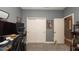 Gray carpeted bedroom featuring a desk, two closets, and decorated with art at 905 Old Windsor Way, Spring Hill, FL 34609
