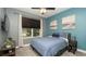 Cozy bedroom with blue accent wall, plush carpet, and a serene atmosphere at 905 Old Windsor Way, Spring Hill, FL 34609