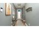 Inviting foyer with light blue walls, wood flooring, and a decorative console table at 905 Old Windsor Way, Spring Hill, FL 34609