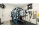 Functional garage area with exercise equipment, weights, and tool organizers at 905 Old Windsor Way, Spring Hill, FL 34609