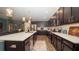 Modern kitchen featuring dark cabinets, stainless appliances, and large island with seating at 905 Old Windsor Way, Spring Hill, FL 34609