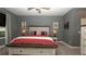 Comfortable bedroom features a king bed, soft lighting, and gray walls at 905 Old Windsor Way, Spring Hill, FL 34609