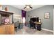 Functional home office setup with multiple desks and comfortable seating for productivity at 905 Old Windsor Way, Spring Hill, FL 34609