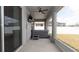 Screened patio area featuring a covered hot tub and ceiling fan at 905 Old Windsor Way, Spring Hill, FL 34609