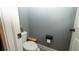 This powder room has a toilet, roll paper holder and small planter at 905 Old Windsor Way, Spring Hill, FL 34609