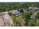 Aerial view of a home featuring a screened pool and well-manicured landscaping in a wooded neighborhood at 9152 Bunting Rd, Weeki Wachee, FL 34613