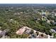 Scenic aerial view of homes nestled within a dense forest, some featuring pools in a tranquil setting at 9152 Bunting Rd, Weeki Wachee, FL 34613