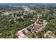 Panoramic aerial view showcasing a residential area dotted with lakes and surrounded by verdant forests at 9152 Bunting Rd, Weeki Wachee, FL 34613