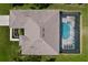 An aerial view reveals a well-maintained home with a screened-in pool and a spacious backyard at 9152 Bunting Rd, Weeki Wachee, FL 34613