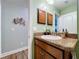Bathroom with wood cabinets, granite countertops, and seahorse wall decor at 9152 Bunting Rd, Weeki Wachee, FL 34613