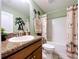 Bathroom features a granite countertop, palm tree decor, and shower-tub combo at 9152 Bunting Rd, Weeki Wachee, FL 34613