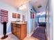 Bright bathroom with light blue walls, wood vanity, and direct access to the main bedroom at 9152 Bunting Rd, Weeki Wachee, FL 34613