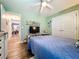 Bright bedroom with ceiling fan, hardwood floors, and serene lighting at 9152 Bunting Rd, Weeki Wachee, FL 34613