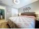 Serene bedroom with hardwood floors, a cozy bed, and stylish lighting at 9152 Bunting Rd, Weeki Wachee, FL 34613