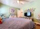 Charming bedroom with coastal decor, ceiling fan, and TV for relaxation at 9152 Bunting Rd, Weeki Wachee, FL 34613