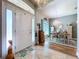 Bright entryway with chandelier, light tile and hardwood floors, and view of formal dining at 9152 Bunting Rd, Weeki Wachee, FL 34613