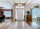 Inviting entryway featuring tile floors, chandelier, and views into the dining room and living room at 9152 Bunting Rd, Weeki Wachee, FL 34613
