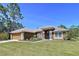 Charming single-story home with a well-manicured lawn and neutral-colored exterior paint at 9152 Bunting Rd, Weeki Wachee, FL 34613