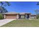 Charming single Gathering home with a two car garage, well-manicured lawn, and inviting curb appeal at 9152 Bunting Rd, Weeki Wachee, FL 34613