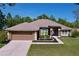 Charming single-story home with a well-manicured lawn and a two car garage at 9152 Bunting Rd, Weeki Wachee, FL 34613